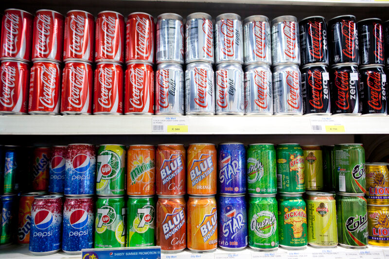 Image of soft drinks, beverages, bottles, and cans at a super market